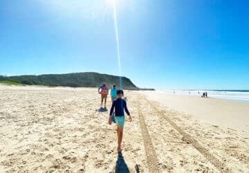 kids walking on tallebudgera beach