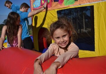 A-Leap Castle Hire smiling child outside bouncing castle.
