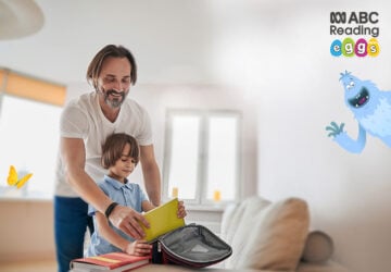 Dad and son unpacking school bag for ABC Reading Eggs