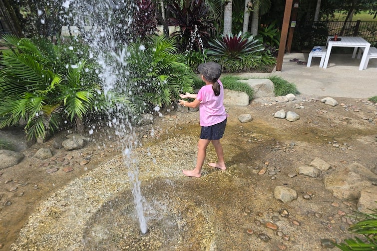 Young girl playing in the water play area at Amaze World.