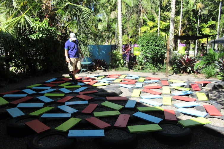 Man at tyre maze at Amaze World