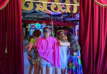 Group of kids waiting to enter red curtains at Archie Brothers Toombul
