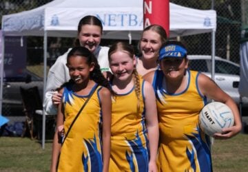 Aspley Devils Netball Club team posing and smiling.