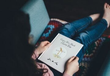 teenager reading a book borrowed at the library