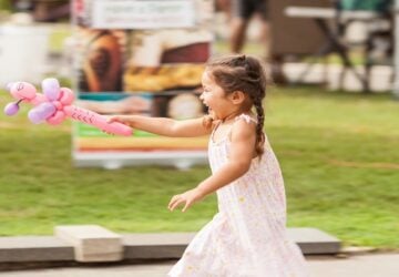 Girl with balloon at Carseldine Markets