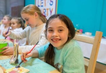 Girl smiling with paintbrush