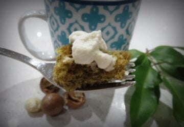 Piece of cake on fork with cream on top