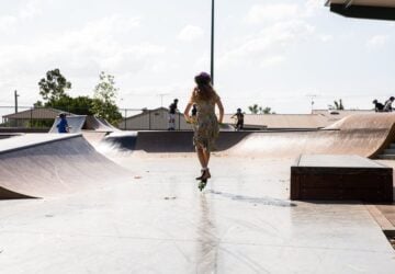 Logan village skatepark girl learning to jump on scooter