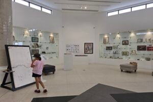 A young girl looking around The Mathema Gallery.