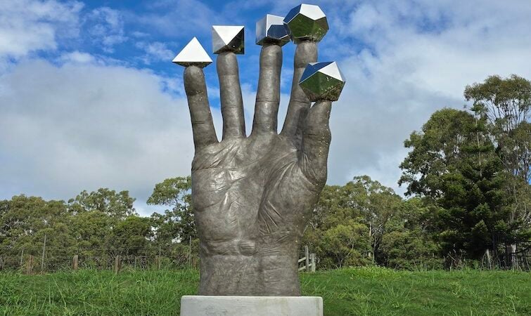 The Hand of Plato sculpture on the grounds of The Mathema Gallery.