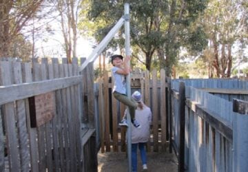 Girl climbing pole in Granite Belt Maze