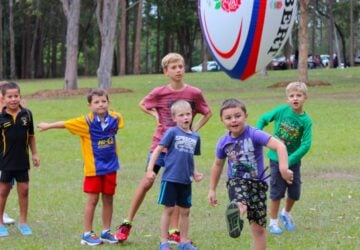 Physi kids kicking football