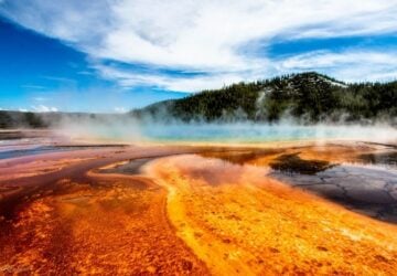 view of steaming hot pool with distant mountain