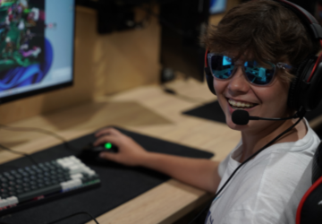 Endgame Esports smiling child gaming at pc.