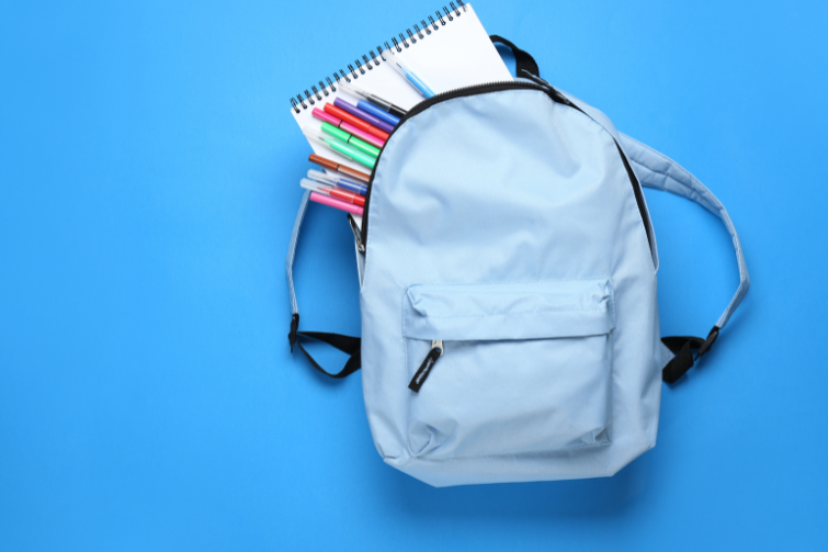 donated school supplies in a blue bag.