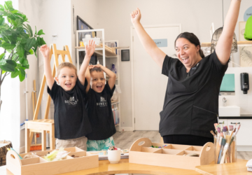 Sorella Early Learning in Griffin children with carer arms in the air.