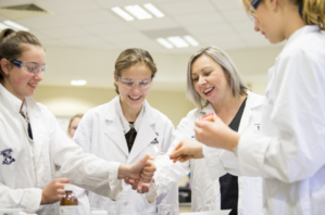 St Margaret's students with teacher in science lab.